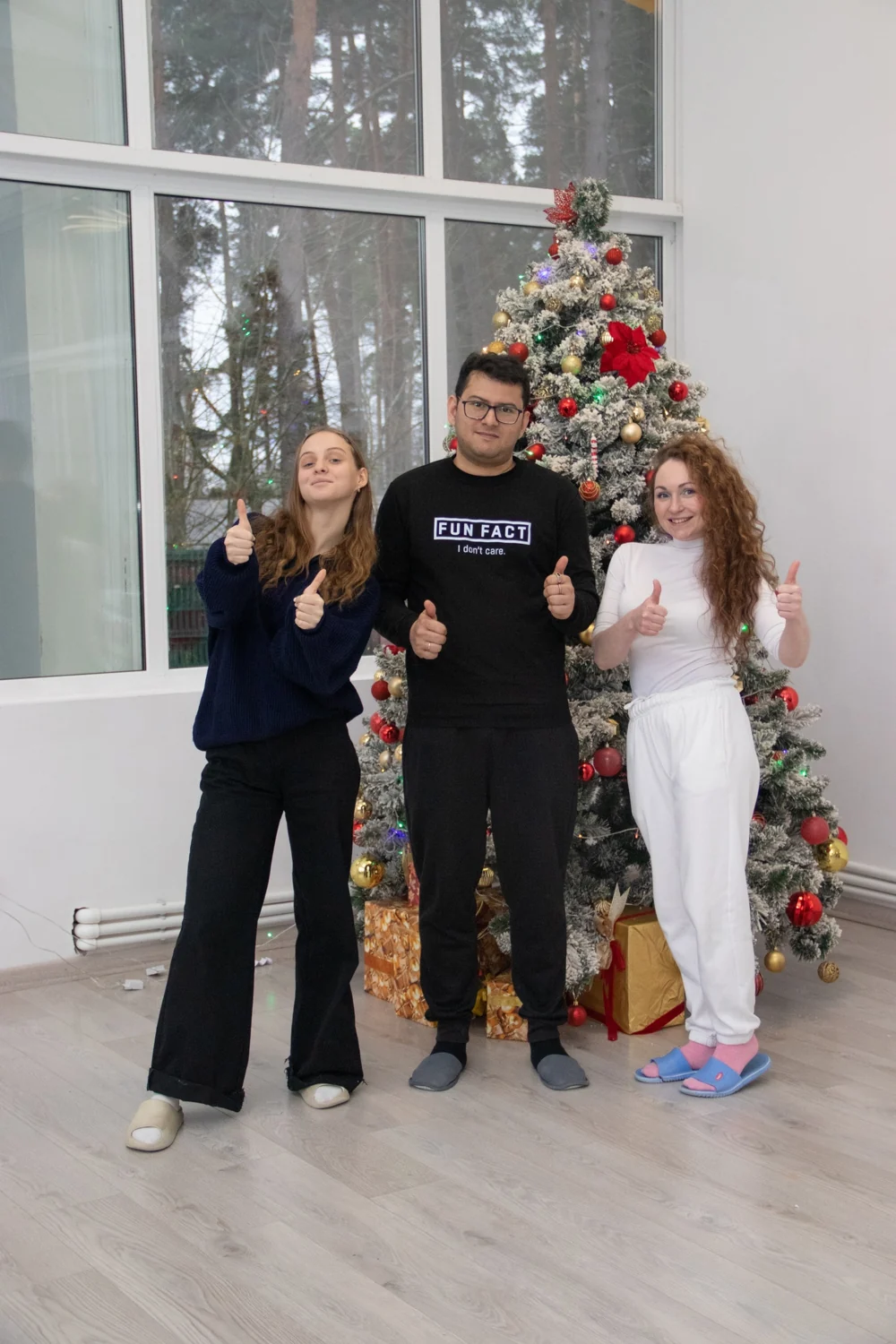 Ronnie with two fellow camp participants beside a decorated Christmas tree